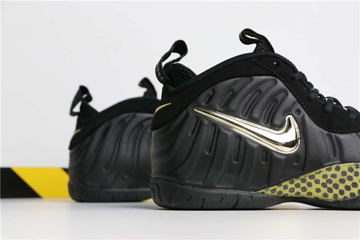 all black foams with gold nike sign