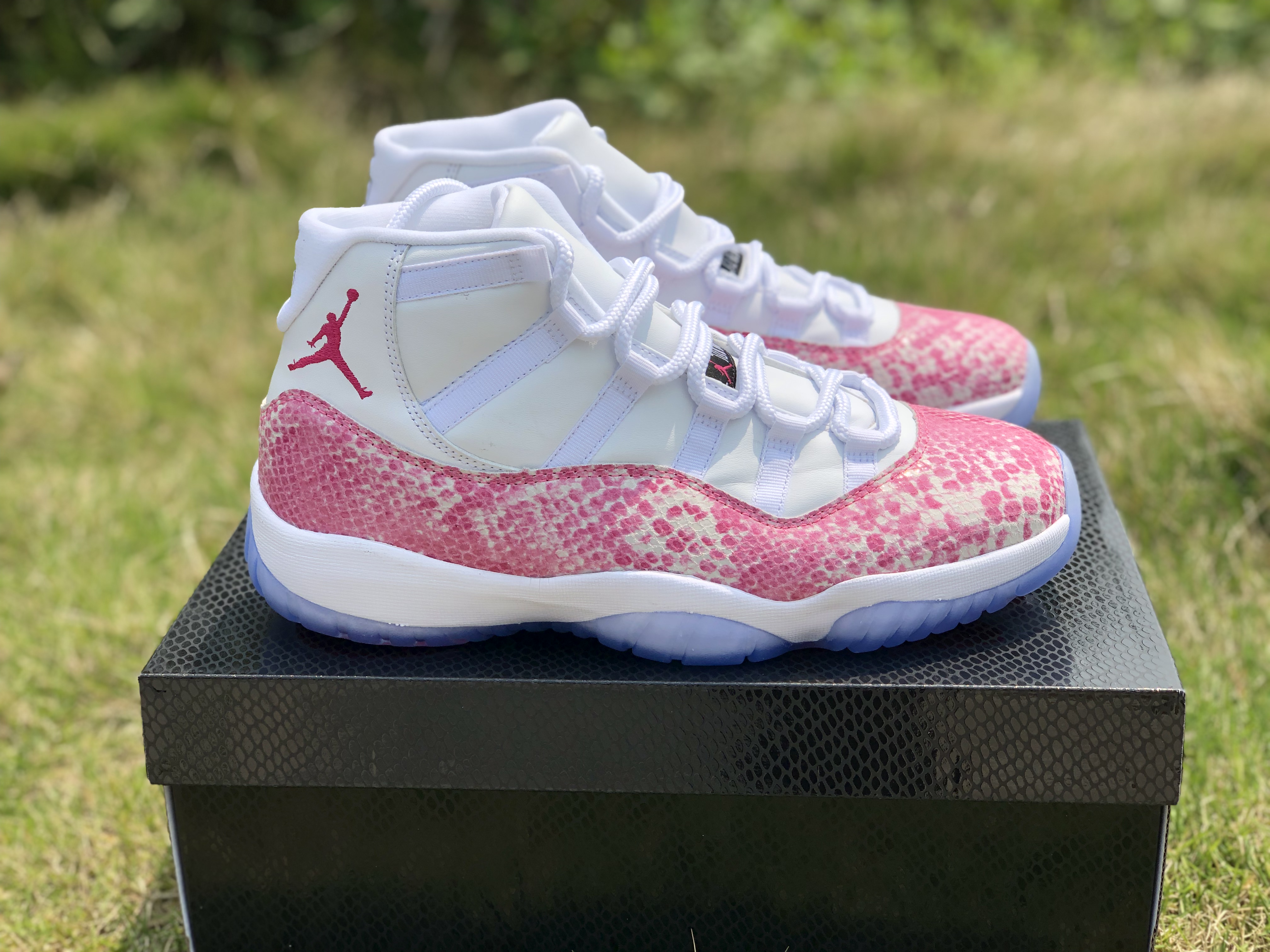 white and pink snakeskin 11s