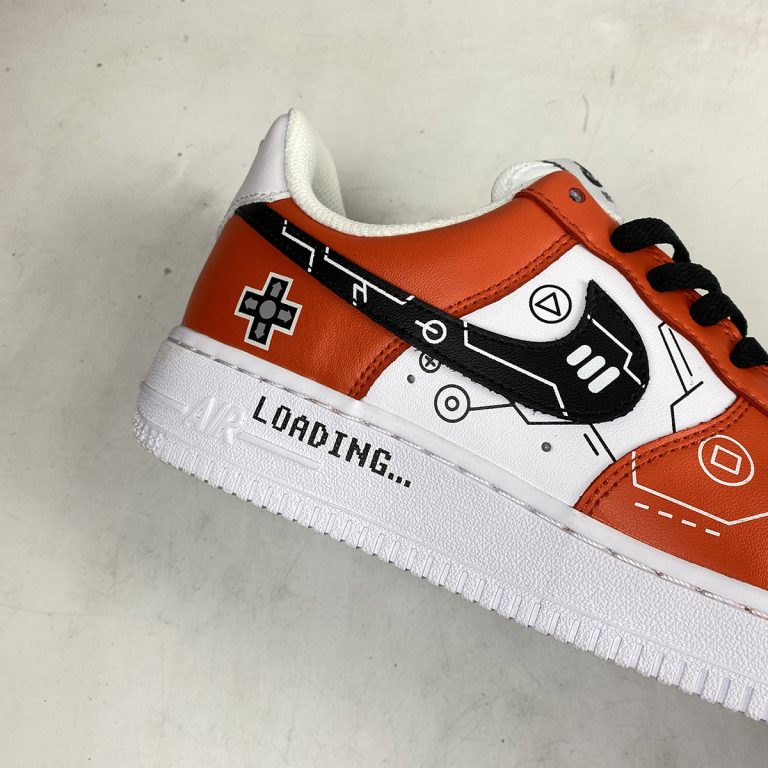 white and black air forces with orange lettering